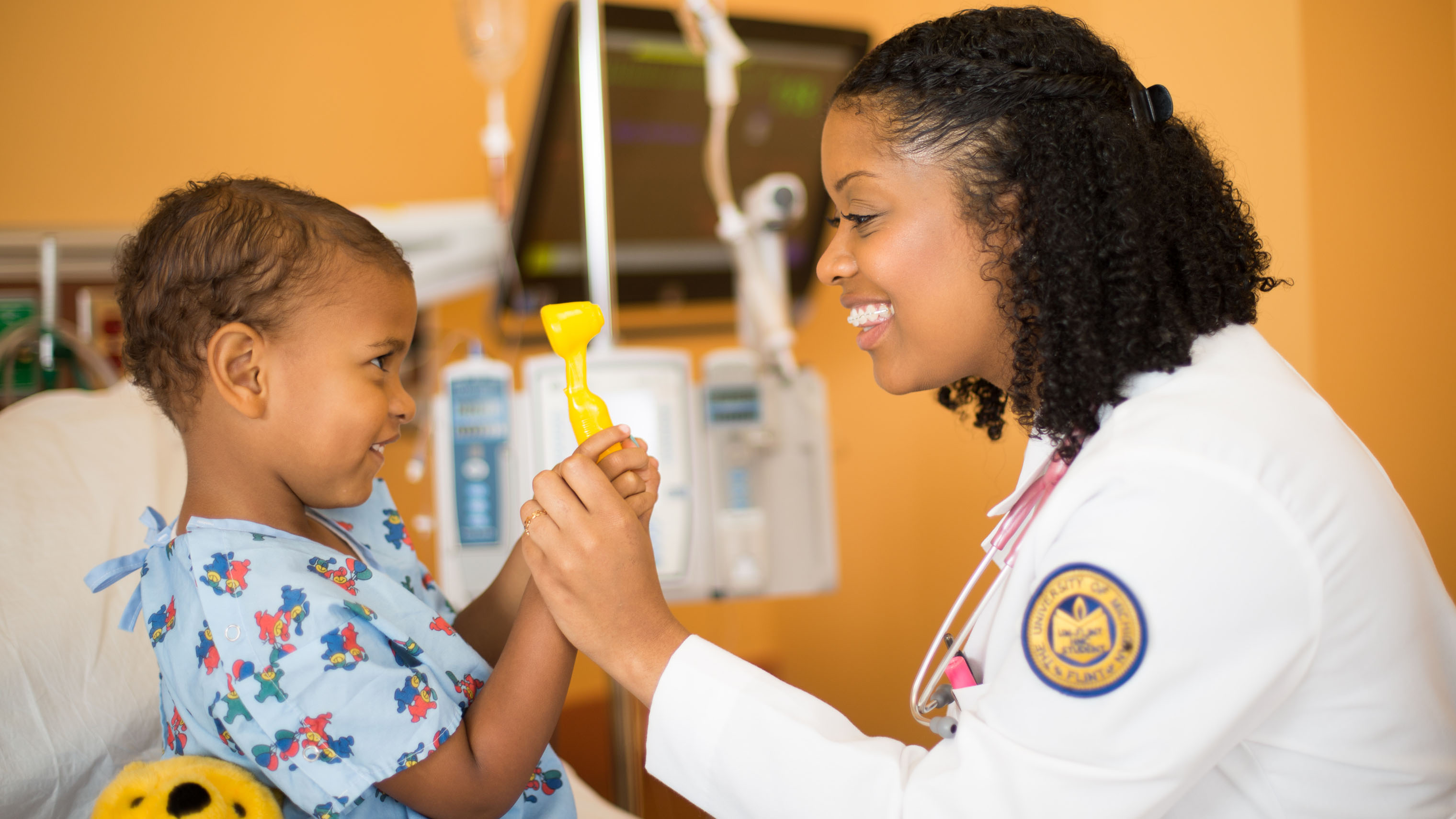 University of Michigan-Flint nursing student treating a pediatric patient