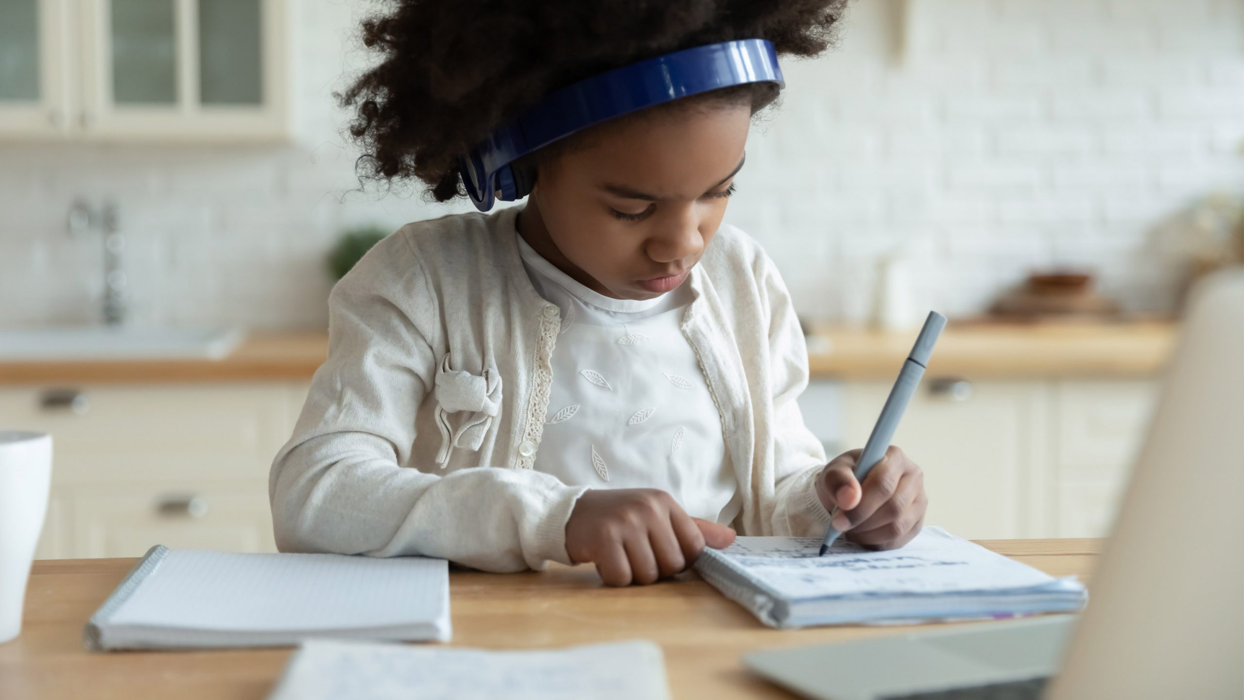 Young student attends school virtually from home