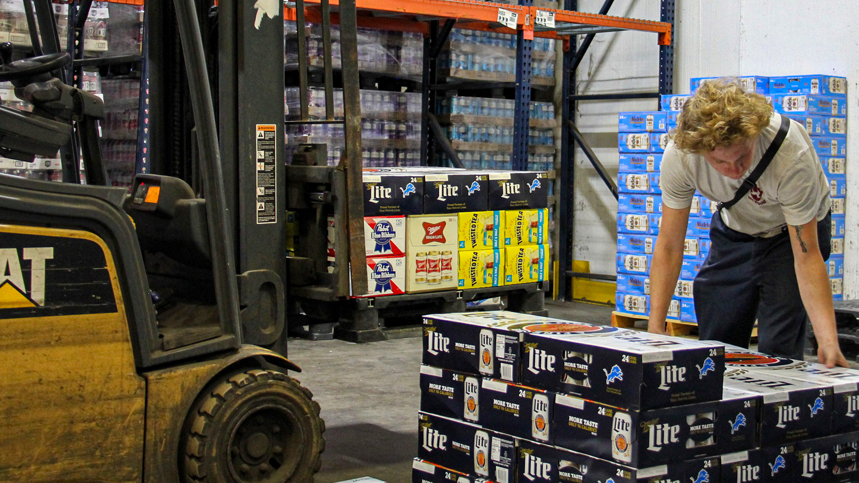 Employee works in a beer distributor warehouse