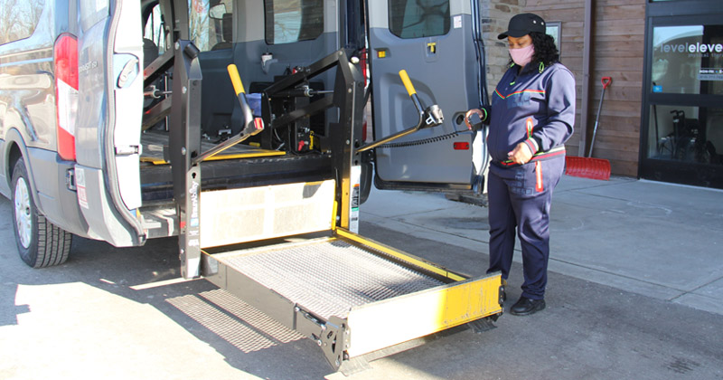 Employee at Dixie Lodge Rehab gets van ready to transport a resident