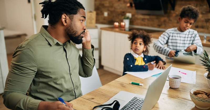 A Father tries to work from home with children around