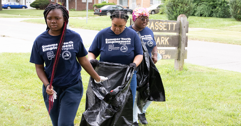 students participate in a park clean-up