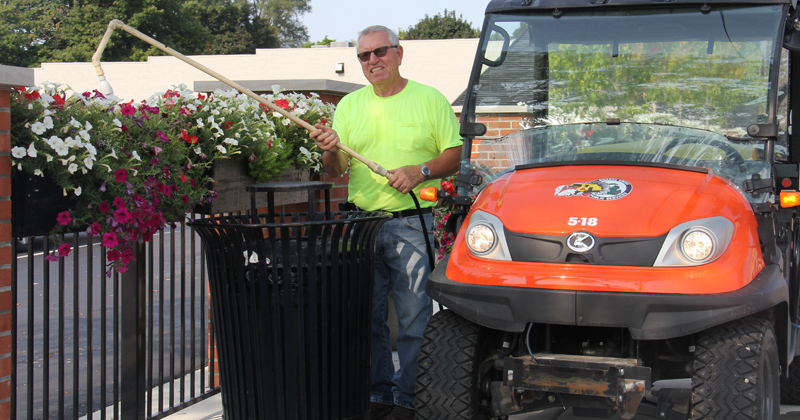 Swartz Creek employee watering city flowers