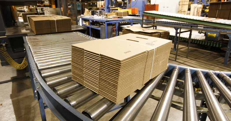Boxes coming off conveyer at Landaal Packaging Systems