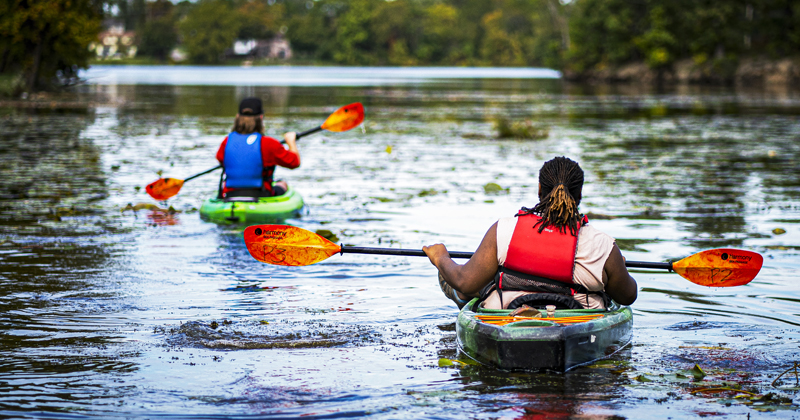 People kayak the Flint River