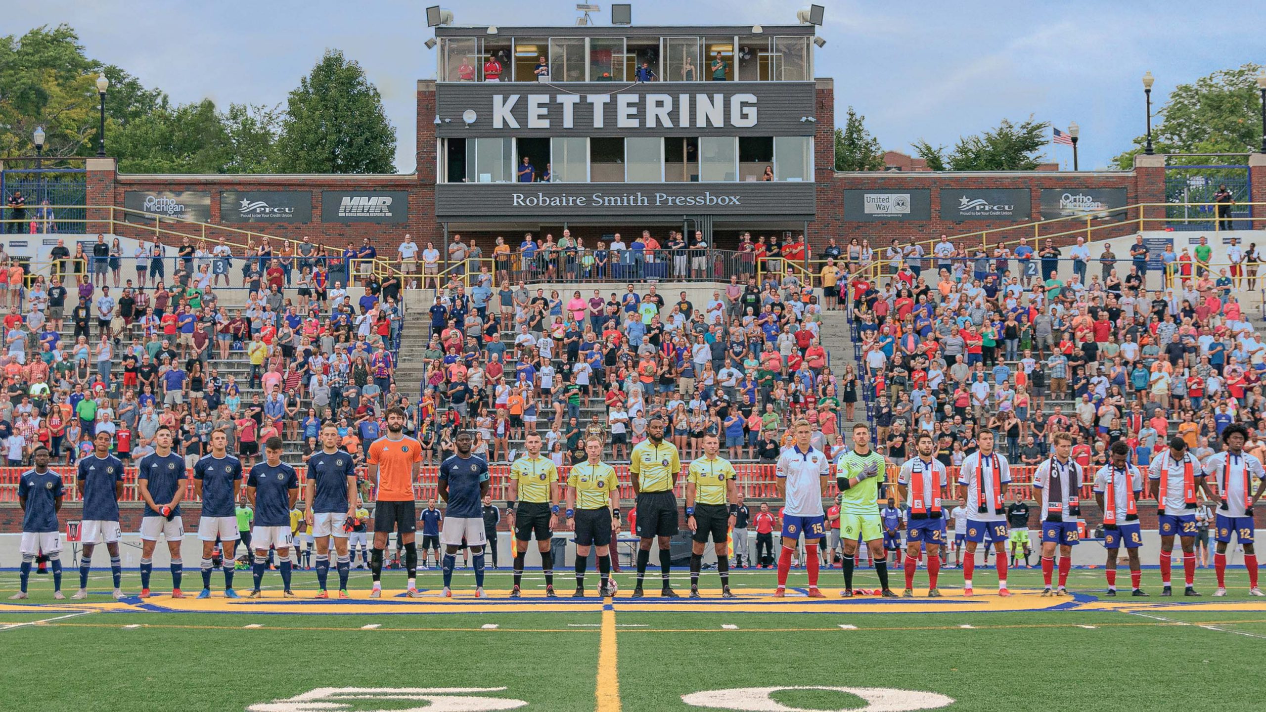 Soccer teams line up for National Anthem at Atwood Stadium