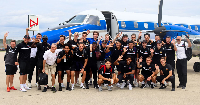 Flint City Bucks players board a plane for a playoff game