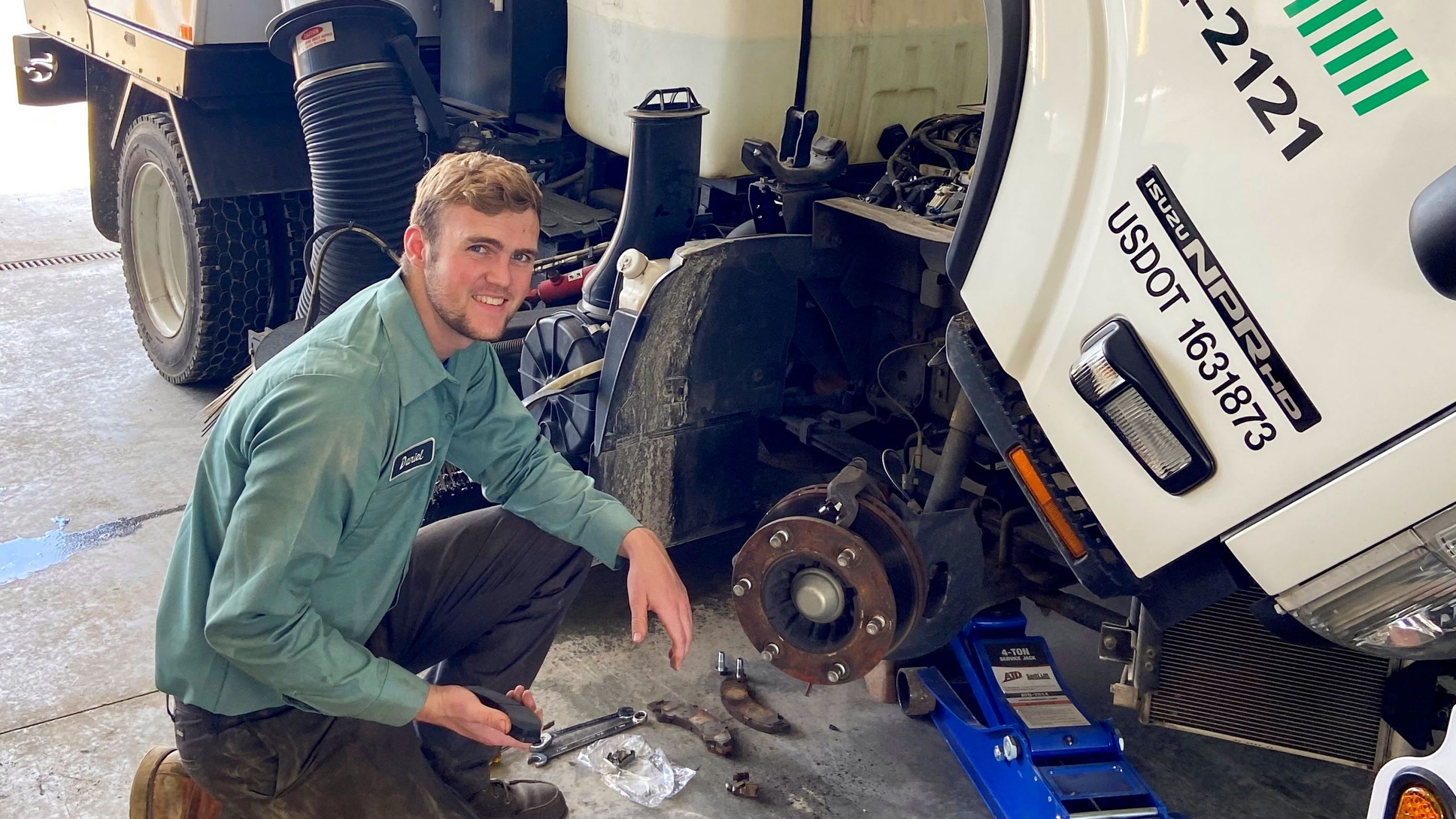 Apprentice at Curbo works on a truck