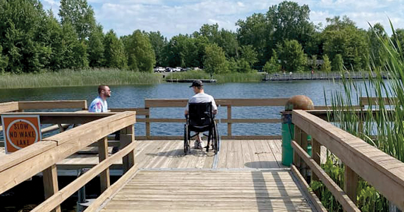 Wheelchair bound man fishes off dock
