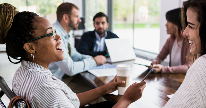 Happy employees meeting around a table