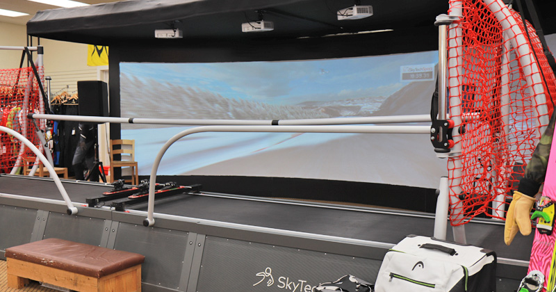 SkyTechSport ski and snowboard simulator inside the Shumaker Ski shop is a 25 feet wide with three projectors and recreates the look and feel of snow sports.
