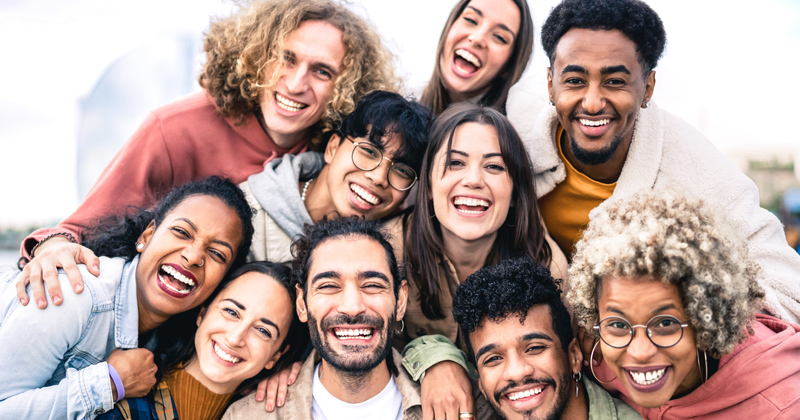 A very diverse group of people pose for a group photograph