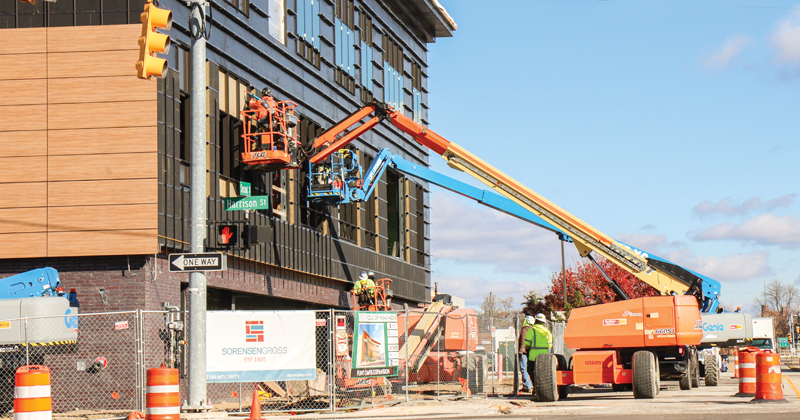 Construction workers work on the windows on the expansion of Michigan State University's College of Human Medicine in downtown Flint.
